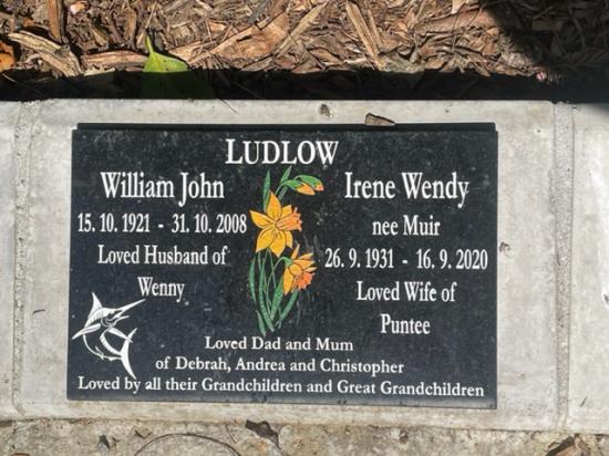 Black granite companion cremation plaque with white inscription + flower illustration