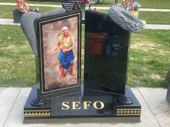 Custom double headstone with flat top, a large photo, and carved decorations - crafted from polished granite by Mark Memorials in Levin, New Zealand.