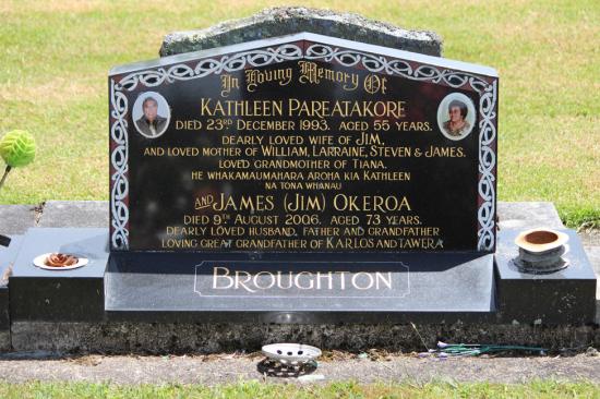 Classic upright companion headstone with gable top, including a maori design and photos. Crafted from polished granite by Mark Memorials in Levin, New Zealand.