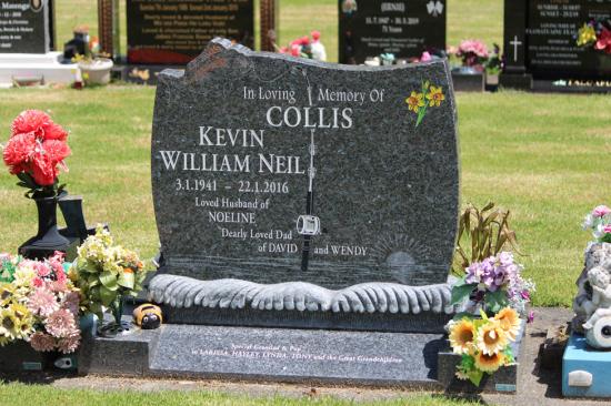 Custom upright companion headstone with custom top and fishing design, with sculpted waves -  crafted from polished granite by Mark Memorials in Levin, New Zealand