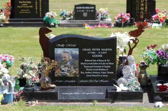 Classic upright headstone with a wave top, showing a large ceramic photo. Crafted from polished granite by Mark Memorials in Levin, New Zealand.