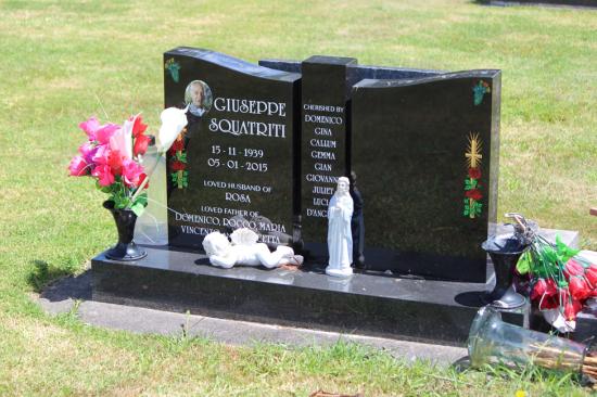Modern upright double headstone with split low saddle top - reverseed , crafted from polished granite by Mark Memorials in Levin, New Zealand.