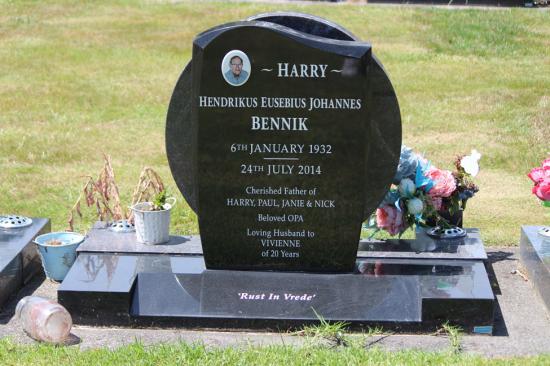 Modern upright double headstone with wave top , crafted from polished granite, by Mark Memorials in Levin, New Zealand.
