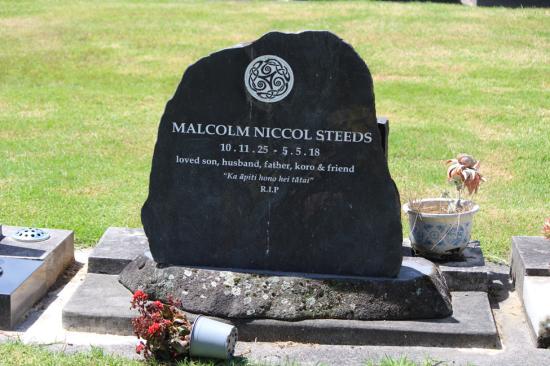 Natural stone headstone with a space left for an additional person to be added.