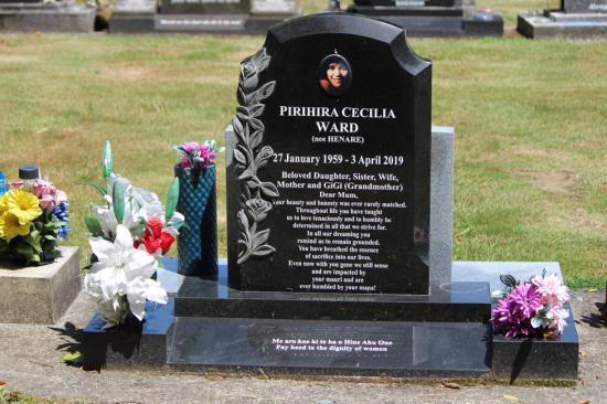 Custom tall upright headstone with carved flowers and a photo, crafted from polished granite by Mark Memorials in Levin, New Zealand