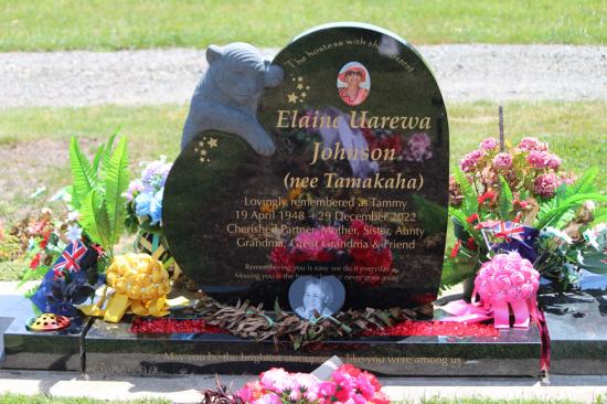 Custom upright headstone in a heart shape with a custom carved animal and photos, crafted from polished granite by Mark Memorials in Levin, New Zealand