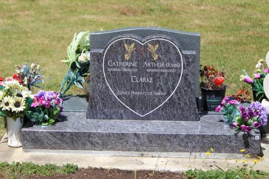 Classic upright double companion headstones in a heart shape, crafted from grey polished granite